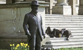 Bronze statue of King Wilhelm II with a dog, in front of the Wilhelm's Palace in Stuttgart