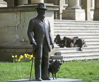 Bronze statue of King Wilhelm II with a dog, in front of the Wilhelm's Palace in Stuttgart