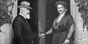 The royal couple in traditional clothing in front of Bebenhausen Palace